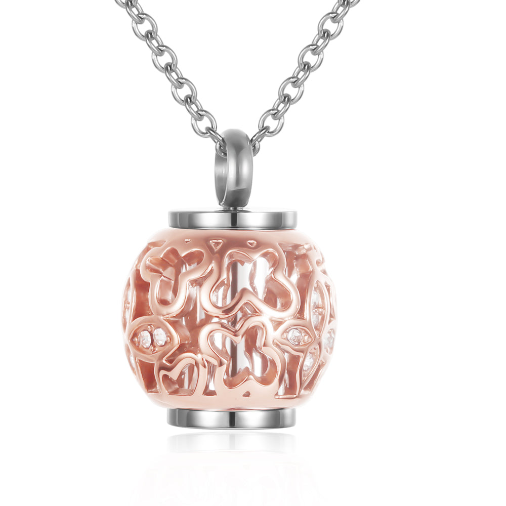 Rose gold tone memorial urn pendant featuring intricate butterfly cutouts and crystals, perfect for ashes keepsake jewelry in stainless steel.