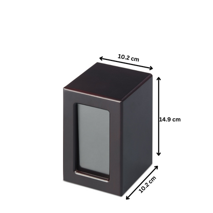 Medium Mahogany Photo Urn with timber veneer frame, 14.9cm height and 10.2cm width. Includes photo slot and ashes compartment.