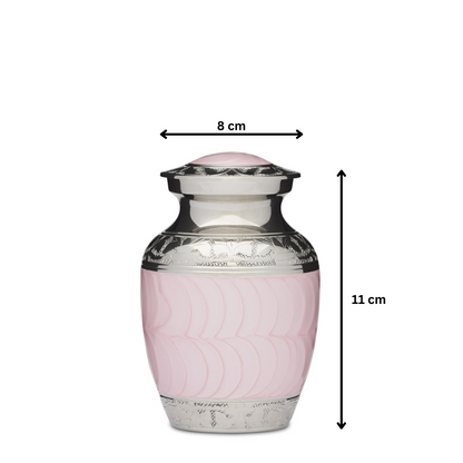 Small pink enamel and nickel urn measuring 11 cm tall and 8 cm wide. Solid brass construction with threaded lid and felted base for ashes.