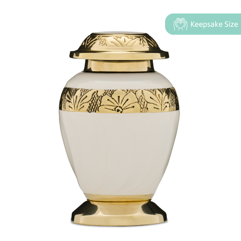 Embassy Gold White Urn Keepsake in solid brass with gold floral engraving and threaded lid. Elegant keepsake urn includes a velvet storage box.