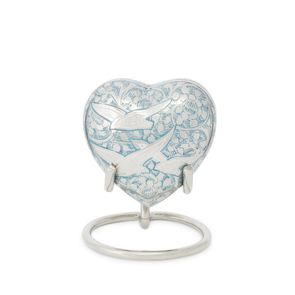 Birds in Flight Heart Keepsake displayed on a silver stand, a memorial gift in brass and silver with bird etching and velvet box.