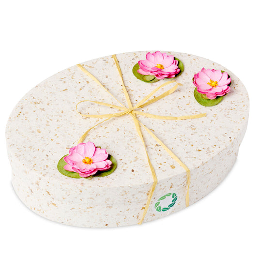Ocean Urn Lotus Flower by Life Cycle Urns featuring a biodegradable oval container with pink lotus flower accents. Ideal for ocean memorial ceremonies.