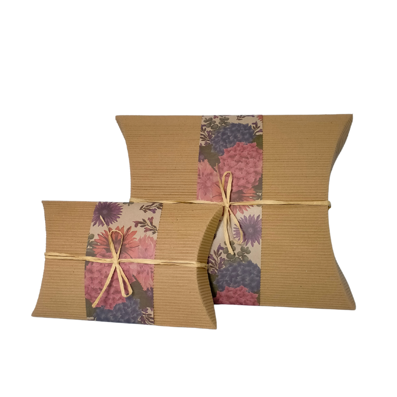 Large biodegradable bio burial urn with hydrangea floral band, made from recycled cardboard for eco-friendly ground cremation burial.