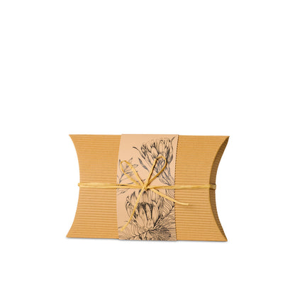 Small Burial Urn Natives made from recycled cardboard with native floral print and yellow tie, ideal biodegradable urn for eco-friendly ground burial.