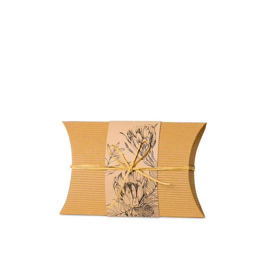 Small Burial Urn Natives made from recycled cardboard with native floral print and yellow tie, ideal biodegradable urn for eco-friendly ground burial.