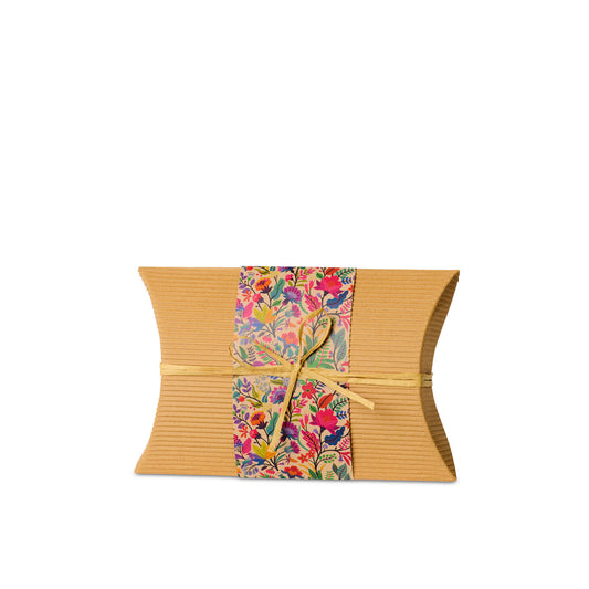 Bio Burial Urn Wilds Small made from eco-friendly cardboard with a floral wrap and raffia tie, ideal for ground cremation burials.