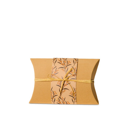 Small biodegradable burial urn made from recycled cardboard with floral wrap and twine. Eco-friendly cremation urn by Life Cycle Urns.