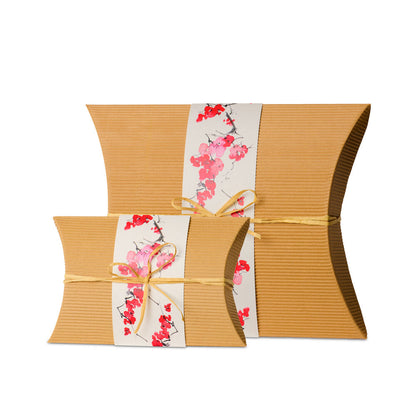 Set of biodegradable burial urns in adult and keepsake sizes, crafted from recycled cardboard with floral wrap for sustainable cremation solutions.