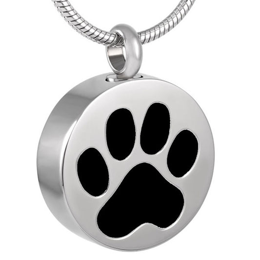 Round Pet Paw Print Pendant in stainless steel with black enamel paw design. Pet memorial jewelry for holding ashes, includes cord and funnel.
