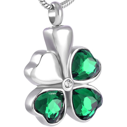 Four Leaf Clover Pendant - Jewelry | Stainless Steel Design with green gemstone leaves and ash enclosure, includes velvet bag and cord.