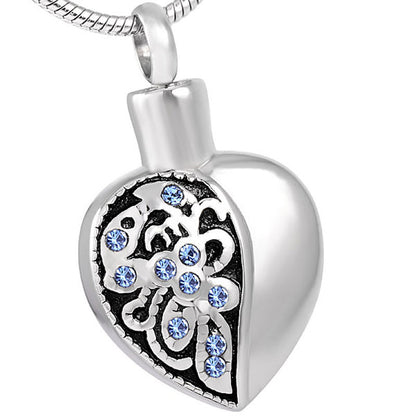 Bluestone Heart - Heart bluestone pendant in stainless steel with blue crystal inlays and floral design, includes velvet bag and satin cord.