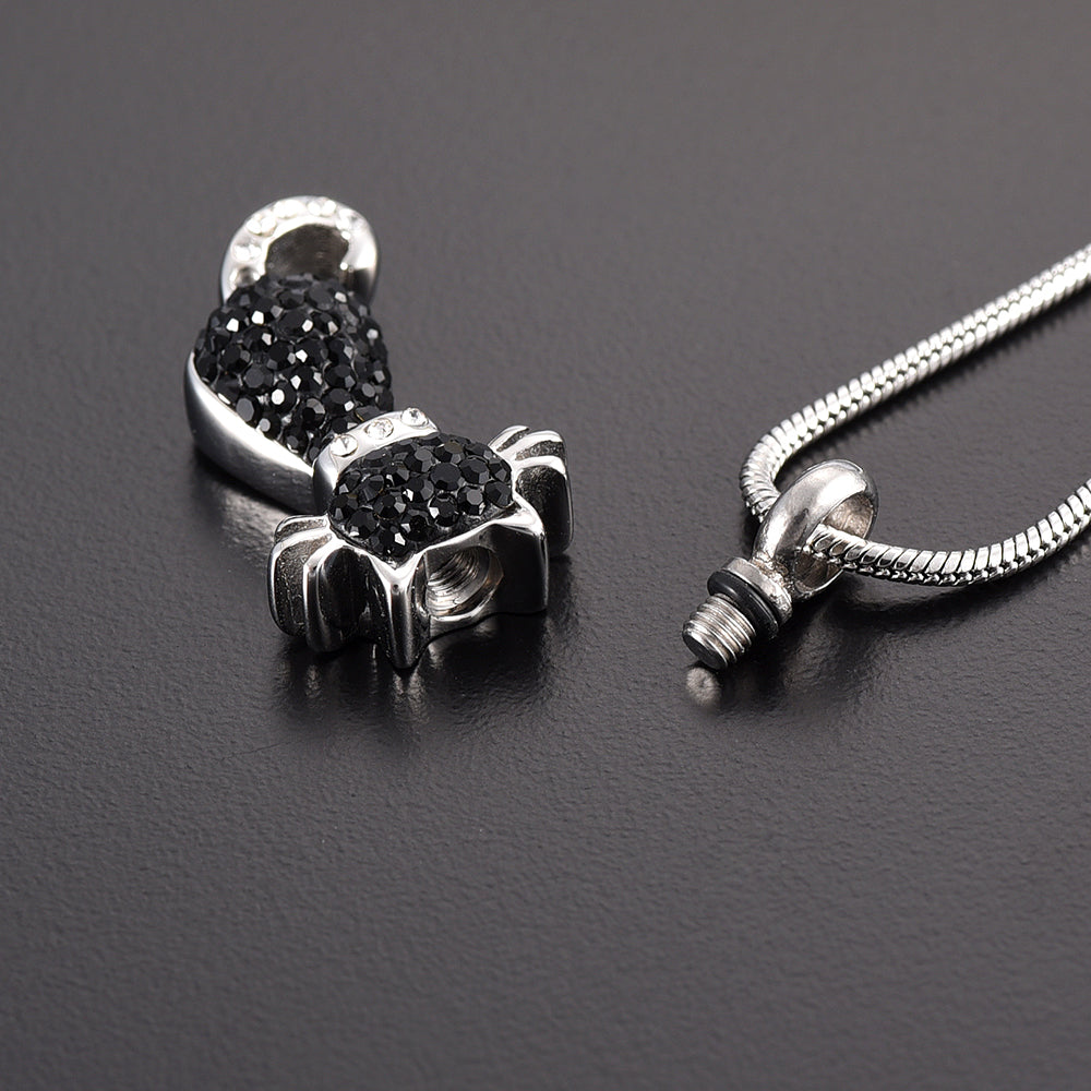 Stainless steel Black Cat Pendant unscrewed to reveal ashes compartment, adorned with black crystals and includes a snake chain for wearing.