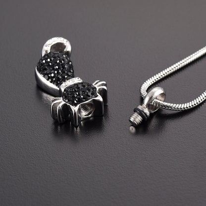 Stainless steel Black Cat Pendant unscrewed to reveal ashes compartment, adorned with black crystals and includes a snake chain for wearing.