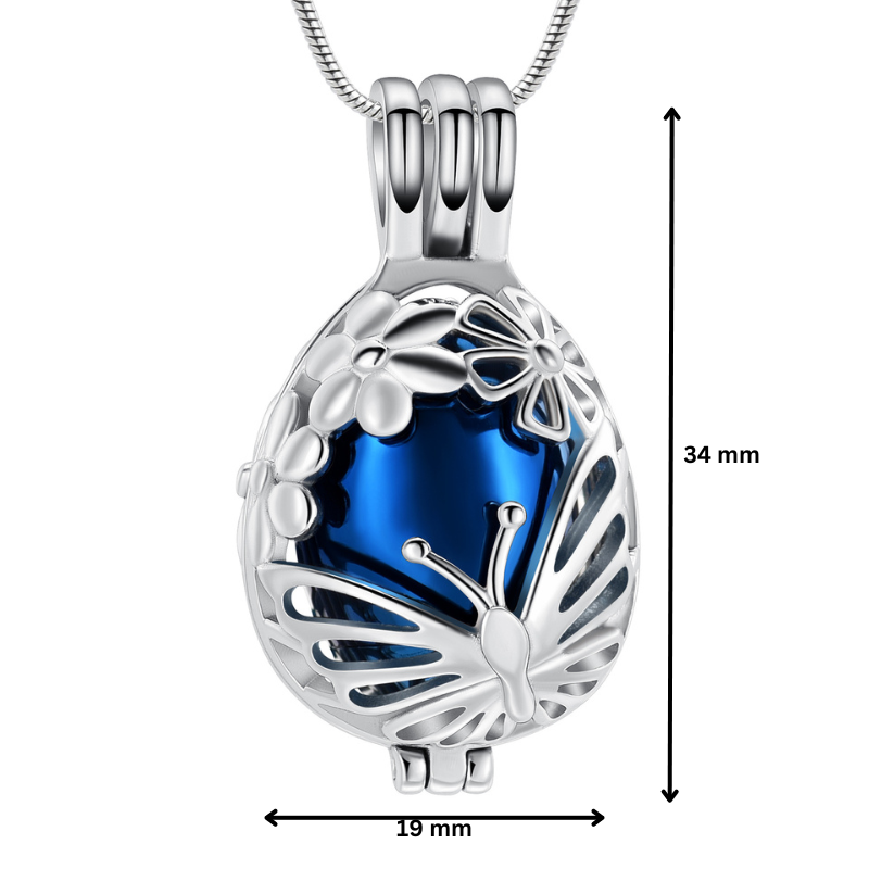 Butterfly Memorial Pendant in blue with stainless steel butterfly overlay, measuring 34mm x 19mm. Ash urn necklace for remembrance.