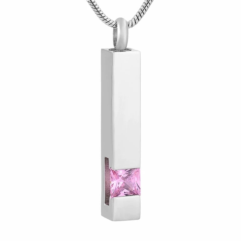 Column Pendant with Pink Stone in stainless steel, designed as a cremation jewelry keepsake. Features a sleek rectangular shape and velvet bag included.