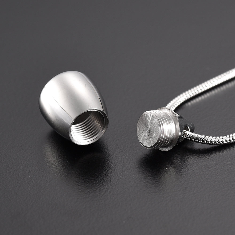 Flat Bottom Teardrop Pendant unscrewed to show internal compartment. Stainless steel necklace for ashes or memorial keepsakes.