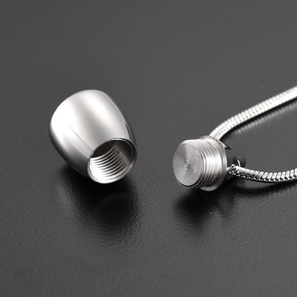 Flat Bottom Teardrop Pendant unscrewed to show internal compartment. Stainless steel necklace for ashes or memorial keepsakes.