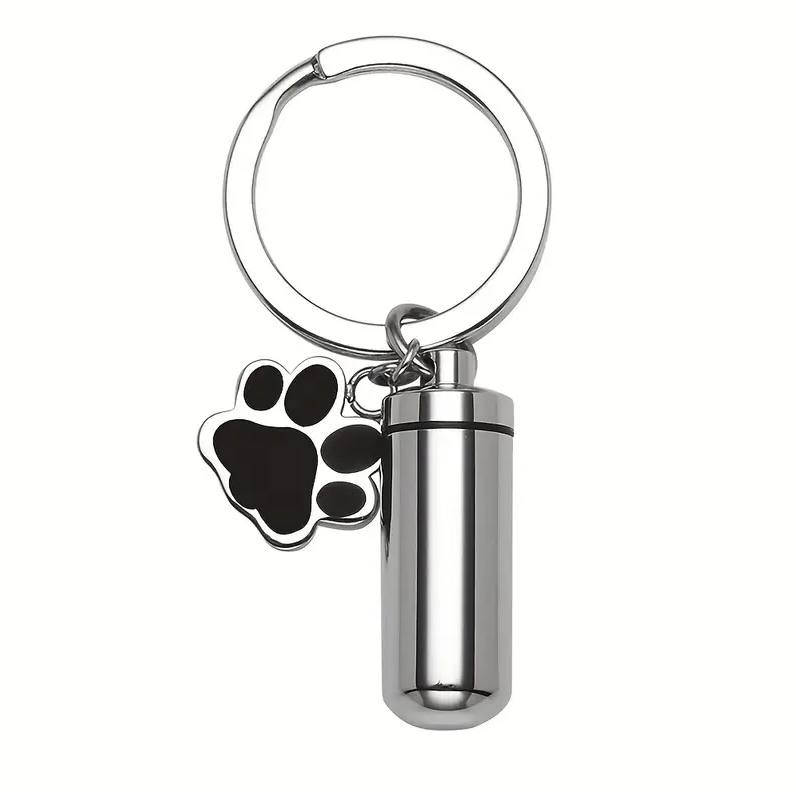Black Paw Print Key Chain - Pet Memorial Keychain in stainless steel with silver tone capsule and black enamel paw charm. Holds small ashes amount.
