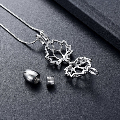 Lotus Urn Pendant Silver Tone - Keepsake Jewelry | Stainless Steel shown open with threaded urn capsule and accessories on dark background.