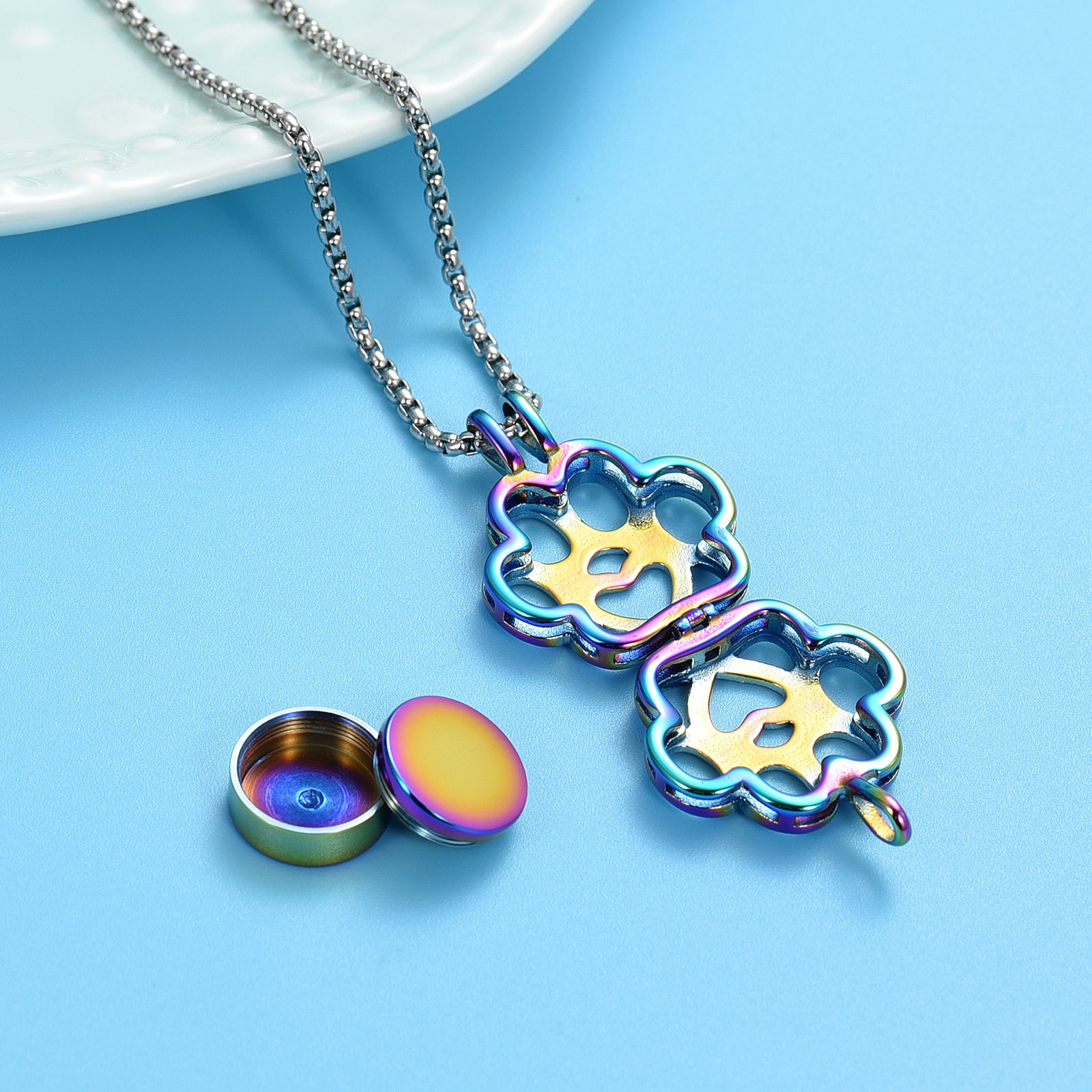 Open Rainbow Paw Print Urn Pendant showing ash holder compartment and funnel cap. Secure design for storing pet ashes discreetly.