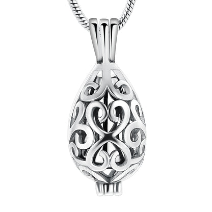 Silver urn pendant in teardrop shape with intricate scroll design, crafted from stainless steel. Ideal keepsake necklace for ashes or memorial use.