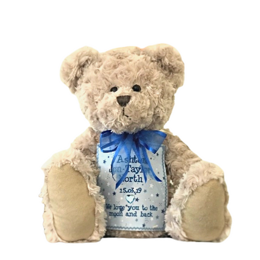 Classic teddy bear cremation urn with custom blue memorial patch and plush exterior. Elegant keepsake for honoring loved ones.